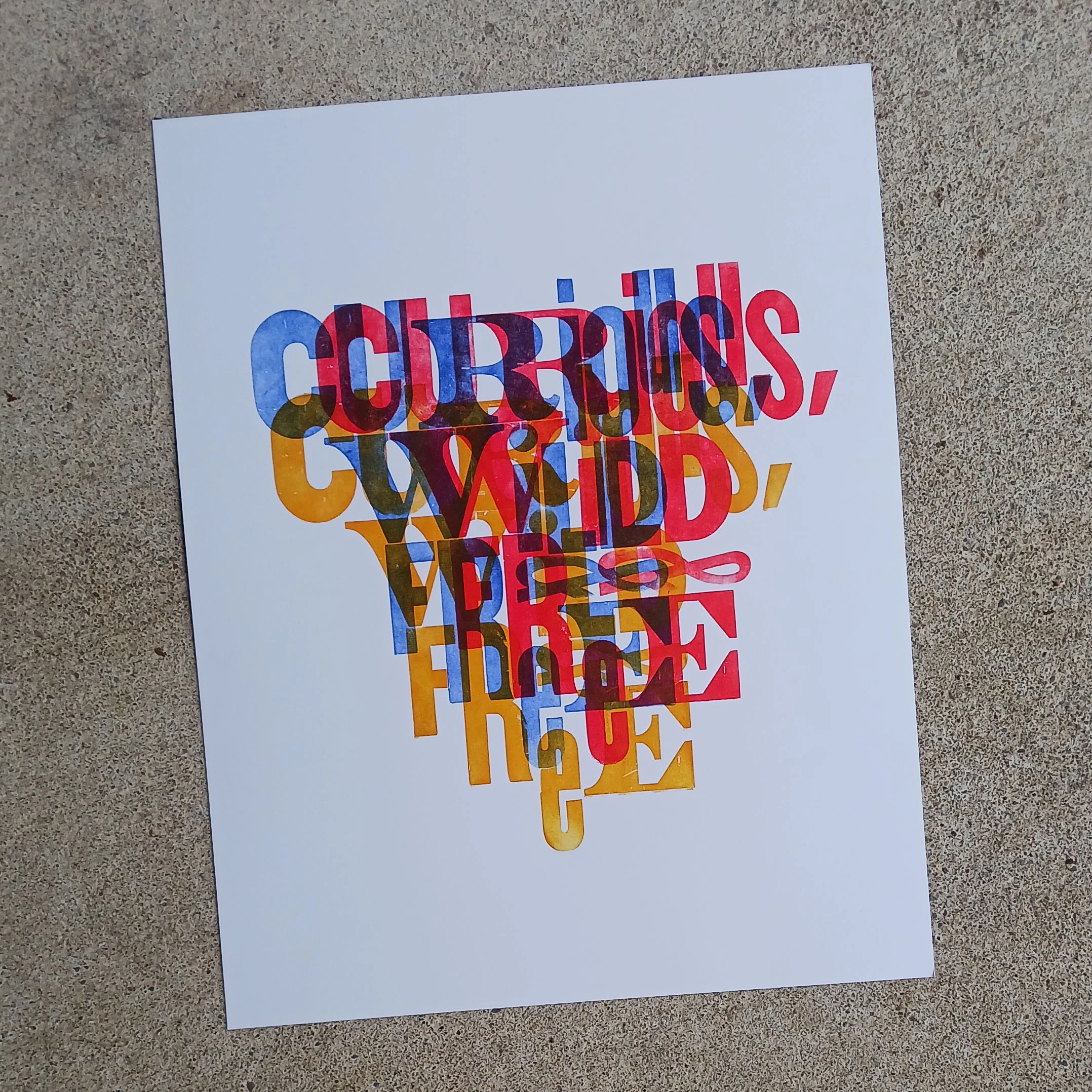 Photograph of a artwork created by Jeffery Macklin titled “wild and free” created on Letterpress features the words “curious, wild, free” overlapping three times in different colors.